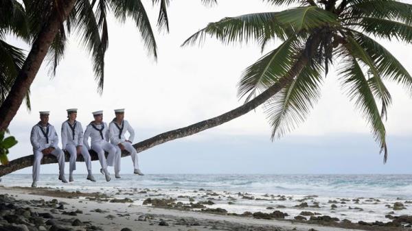 Image of Royal Navy perso<em></em>nnel from HMS Tamar are seen here on a beach in Diego Garcia...Sailors from HMS Tamar wore there tropical 1s uniform to Cannon Corner beach in Diego Garcia. Royal Navy Photographer, Leading Photographer Chris Sellars got his inspiration from an image taken on the island during the end of World War two. The original image had British Military perso<em></em>nnel relaxing in a palm tree awaiting the announcement of the end of World War two...HMS Tamar is on a five-year mission to the Indo-Asia Pacific, with Tamar focusing on her efforts over the winter/early spring of 2023 in the Indian Ocean. The five-year deployment of Tamar and Spey underlines the UK...s commitment to the region..