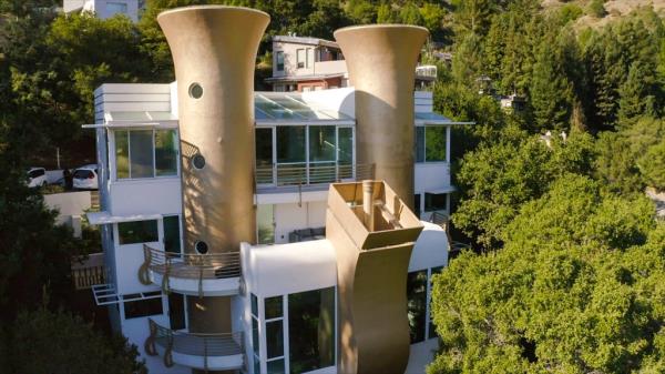 The outside of a home with giant sax. 