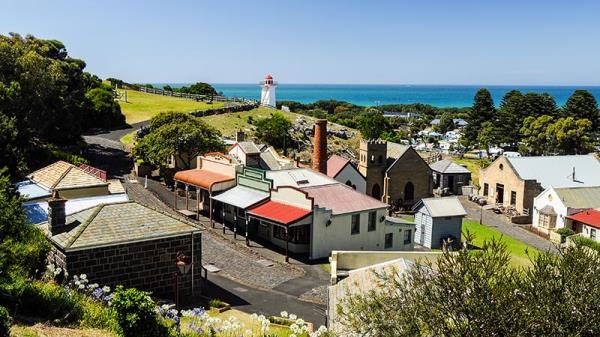 The lighthouse at Warrnambool with federation era shops and houses.