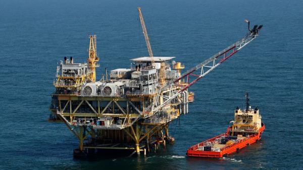 FILE - A rig and supply vessel are pictured in the Gulf of Mexico off the cost of Louisiana, April 10, 2011. A federal judge has ordered the Interior Department to expand next week...s scheduled sale of Gulf of Mexico oil and gas leases by millions of acres. The Thursday, Sept. 22, 2023, ruling rejected a scaled-back plan announced last mo<em></em>nth by the Biden administration as part of an effort to protect an endangered whale species. (AP Photo/Gerald Herbert, File)