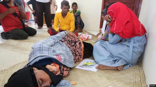 Rohingya Muslim refugees rest at the Samatiga District Office after Indo<em></em>nesian fishermen rescued dozens after high tides capsized their boat in waters off the West Aceh, in Aceh province, Indonesia, March 20, 2024, in this photo taken by Antara Foto.