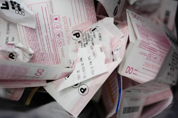 Discarded lottery tickets from past drawings are seen in a trash bin at a 7-Eleven on Friday, April 5, 2024, in Portland, Oregon