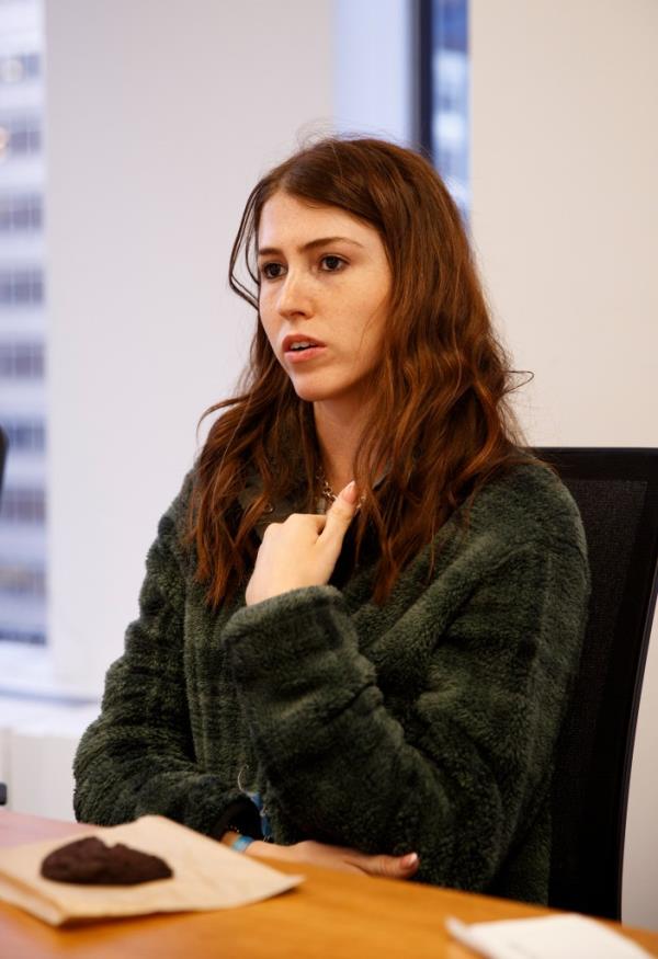 Maya Parizer speaking at a desk.