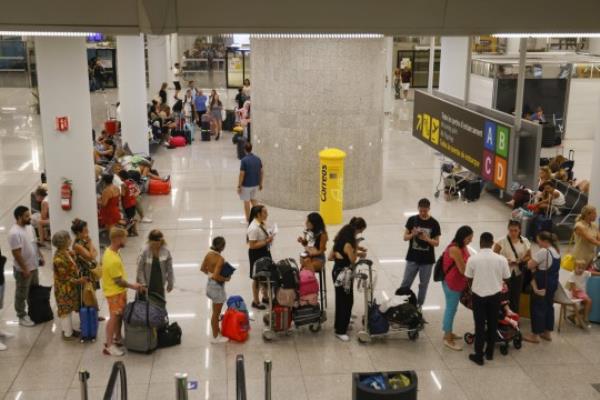 Mandatory Credit: Photo by CATI CLADERA/EPA-EFE/Shutterstock (14071551e) Tourists wait at the airport of Palma for their return flight to Italy due to poor weather co<em></em>nditions in Italy at the Son Sant Joan airport in Mallorca, Spain, 28 August 2023. Poor weather in Italy leaves hundreds stranded at Mallorca airport, Palma De Mallorca, Spain - 28 Aug 2023