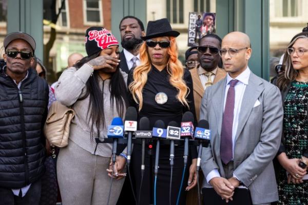 Flanked by family members, attorneys and supporters, Dexter Reed's mother, Nicole Banks, speaks to reporters outside the headquarters for the Civilian Office of Police Accountability in West Town, Chicago, April 9, 2024. (Ashlee Rezin/Chicago Sun-Times via AP)