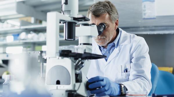 Scientist using microscope in laboratory