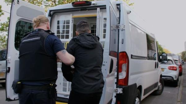 Home Office agents detain someone who is set to be sent to Rwanda. Pic: Home Office