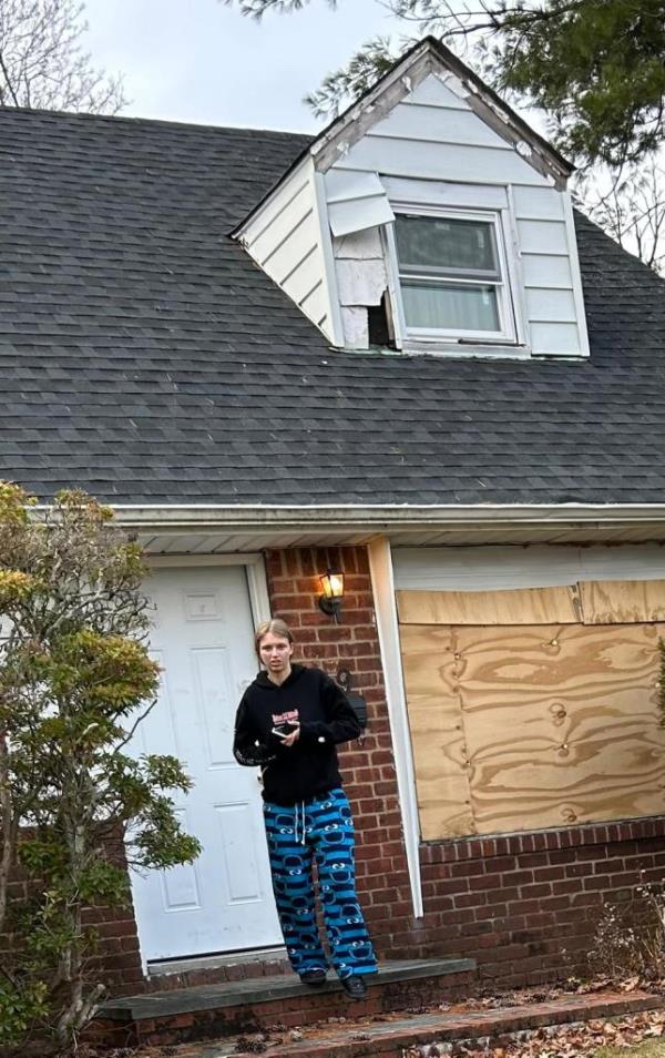 Margaret Grover standing outside a house on 39 Brussel Drive, New Hyde Park, Long Island.