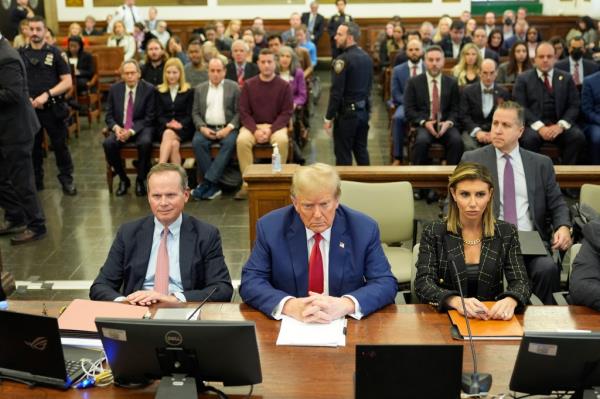 Do<em></em>nald Trump sitting at the defense table next to Alina Habba