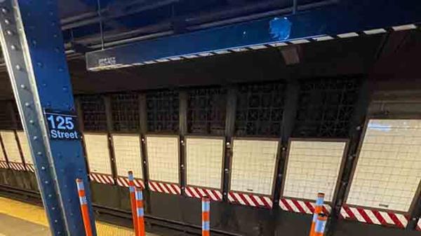 rubber poles around no standing zone on subway platform