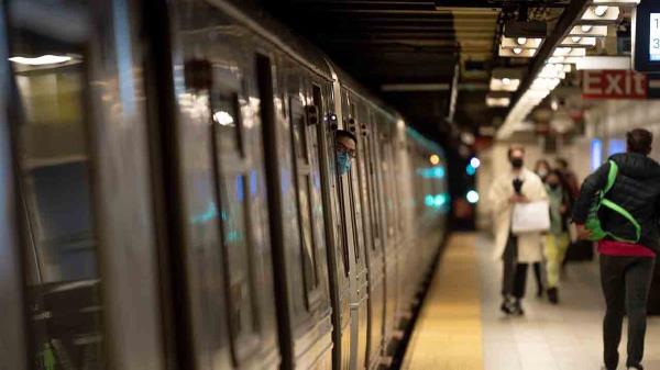 subway co<em></em>nductor peeking out of cabin at station