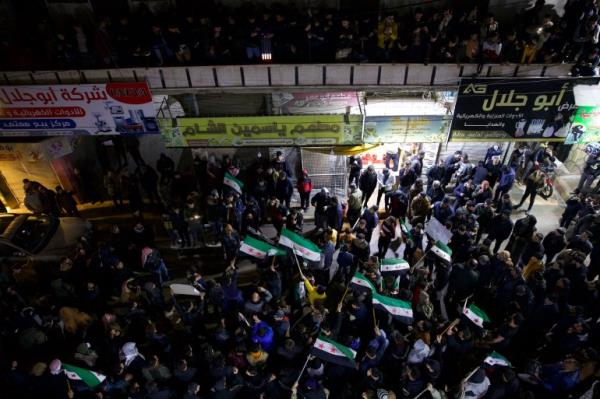 Banner held up saying 'It's great Syria not Assad Syria and not Al Jolane's Syria'