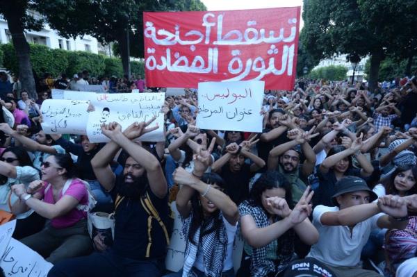 Tunisians block a street during a demo<em></em>nstration in Tunis on May 24, 2024. Several hundred Tunisians marched through the capital chanting 