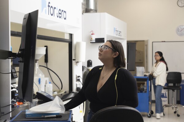 Sarah Plata, center, and Adriana Gutierrez, background right, work at Fortera's facility in San Jose, Calif., Wednesday, April 10, 2024. The cement industry is one of the largest emitters of carbon dioxide and is respo<em></em>nsible for a<em></em>bout 8% of global emissions each year. Fortera, a clean tech company whose technology captures carbon emissions from kilns and feeds it back in to the process, is opening its first commercial scale operation on Thursday, April 12, 2024, in California. (AP Photo/Benjamin Fanjoy)