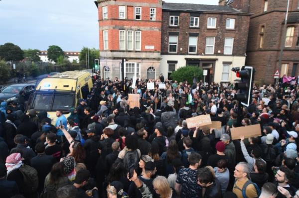A crowd of anti-racism protesters outside an asylum seeker support centre in Liverpool