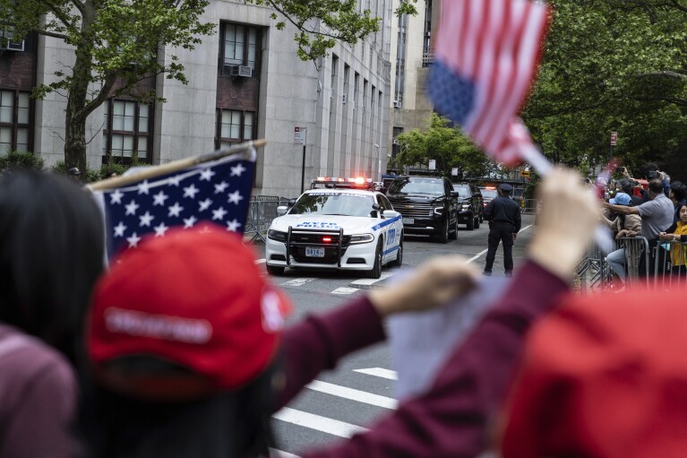 Michael Cohen, right, leaves his apartment building in New York, on May 14, 2024. (AP Photo/Seth Wenig)