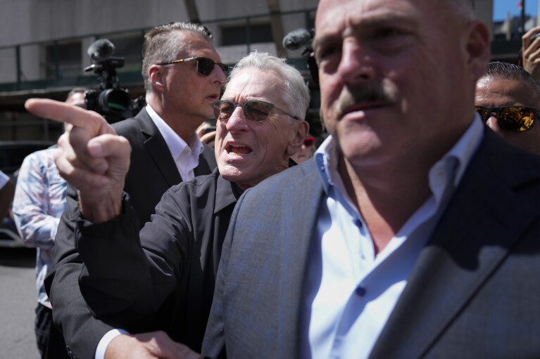 Robert De Niro, center, argues with a Do<em></em>nald Trump supporter after speaking to reporters in support of President Joe Biden across the street from Trump's criminal trial in New York, on May 28, 2024. (AP Photo/Seth Wenig)