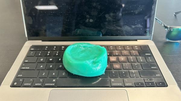 Dust cleaning gel sitting on top of Macbook Pro keyboard