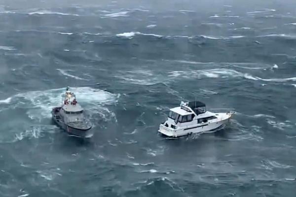 Coast Guard makes dramatic rescue as wave rolls yacht.
