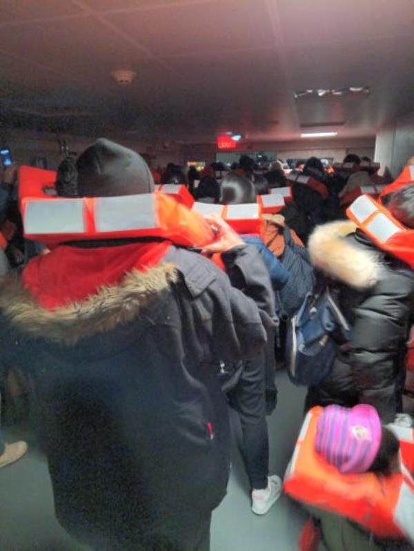 Staten Island Ferry passengers wear life vests.