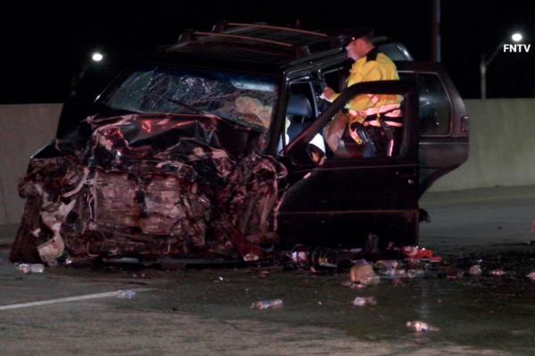 One of the vehicles involved in the crash with the front end entirely smashed up. 