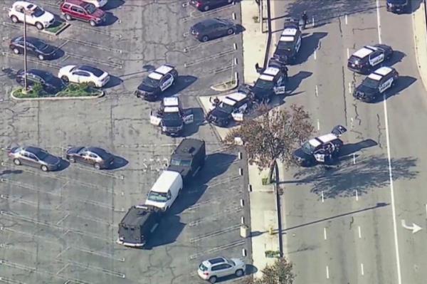 Police use armored vehicles to surround a white cargo van, believed by law enforcement to be co<em></em>nnected to the Mo<em></em>nterey Park mass shooting suspect.