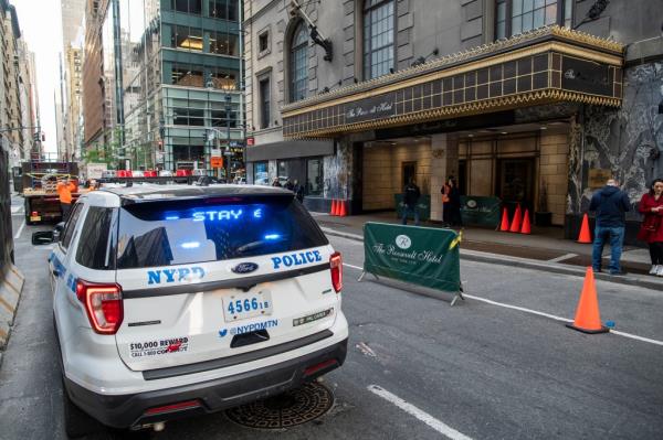 New York Police unit stands guard out side he Roosevelt hotel after the arrival of asylum seekers.