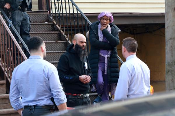 Residents of a nearby home appear shocked after the deadly stabbing on College Avenue near East 170th Street.