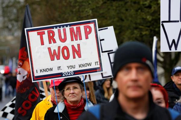 A protester holds a sign saying 