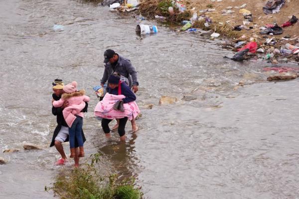 Migrants cross the Rio Grande river into the El Paso from Ciudad Juarez, Mexico, to request asylum on Sunday, December 18.