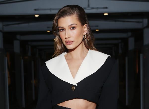 hailey bieber poses at event in black and white ensemble, glazed do<em></em>nut skin routine