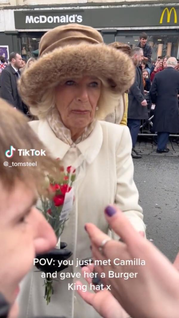 In the video, the Queen Co<em></em>nsort is seen shaking hands with several crowd members before stopping in front of the woman -- who was later identified as Liberty Williams -- who presents the crown to the royal.