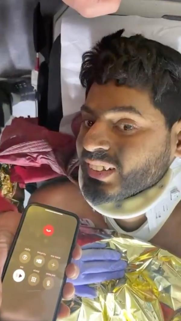 Mustafa Avci speaks to a friend after being rescued Thursday night.