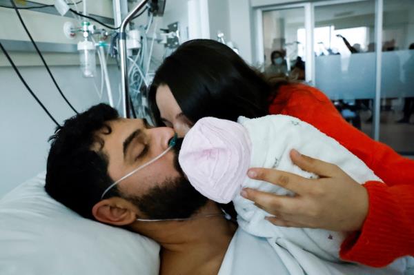 Avci greets his wife, Bilge, and meets his baby daughter Almile for the first time after being rescued.
