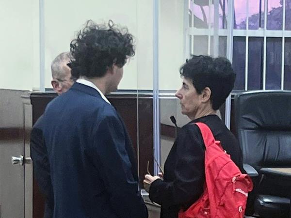 Sam Bankman-Fried, founder of FTX, left, and his mother Barbara Fried at the Magistrate's Court in Nassau, Bahamas, on Tuesday, Dec. 13, 2022. 
