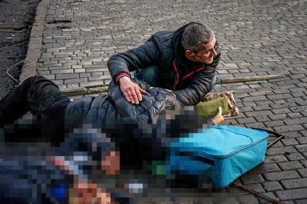 A man helps an injured woman after Russian shelling hit Kherson, Ukraine on December 24.