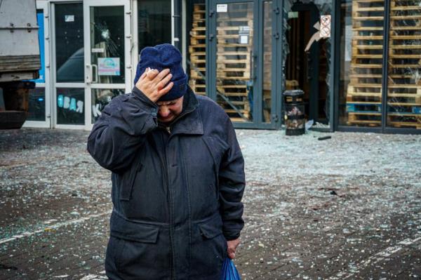 A woman reacts after Russian shelling to Ukrainian city of Kherson on December 24, 2022, wher<em></em>e five were killed and 20 injured.