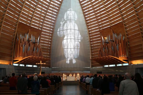 People attend a memorial mass at Cathedral of Christ the Light in Oakland, Calif. 