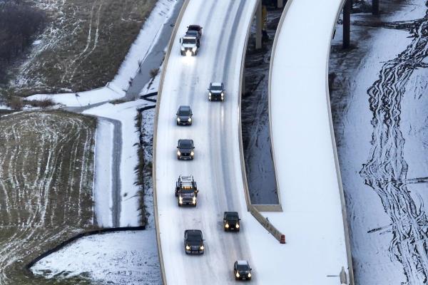 An icy mix covers Highway 114 on Monday, Jan. 30, 2023, in Roanoke, Texas. Dallas and other parts of North Texas are under a winter storm warning through Wednesday. 