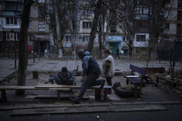 Residents do repair works on a recently damaged building during a Russian strike in the southern city of Kherson, Ukraine, Sunday, Nov. 27, 2022. Shelling by Russian forces struck several areas in eastern and southern Ukraine overnight as utility crews co<em></em>ntinued a scramble to restore power, water and heating following widespread strikes in recent weeks, officials said Sunday.