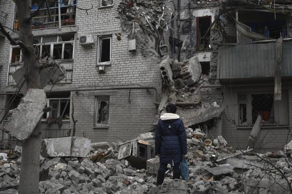 A woman stands among debris of the destroyed house after recent Russian air strike in Chasiv Yar, Ukraine, Sunday, Nov. 27, 2022. Shelling by Russian forces struck several areas in eastern and southern Ukraine overnight as utility crews co<em></em>ntinued a scramble to restore power, water and heating following widespread strikes in recent weeks, officials said Sunday.