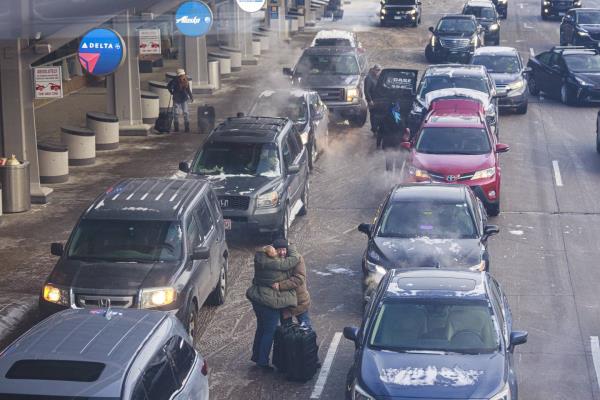 Travelers unload from cars Thursday, Dec. 22, 2022 at Terminal 1 of the Minneapolis-Saint Paul Internatio<em></em>nal Airport in Minneapolis. 