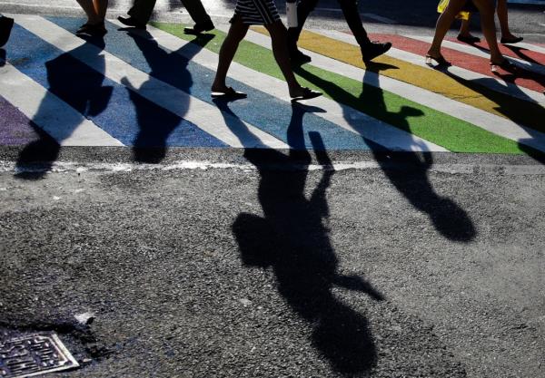 Pedestrians cross the intersection of Christopher Street and Seventh Avenue near the Sto<em></em>newall Inn on June 27, 2019.