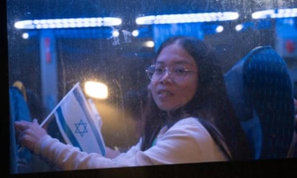 young Thai woman looking out of a bus window