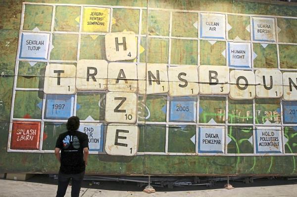A visitor looks at an artwork by Ernest Zacharevic at the 'Haze: Coming Soon' exhibition at REXKL in May this year. Photo: The Star/Low Lay Phon 