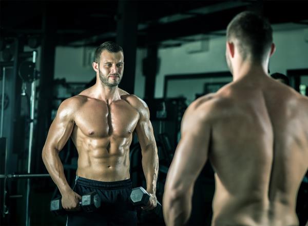 muscular man holding dumbbells, co<em></em>ncept of workout to build strength