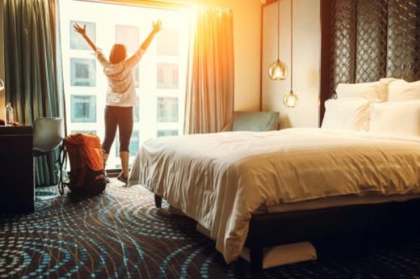 Guest by the Window in a Hotel Room