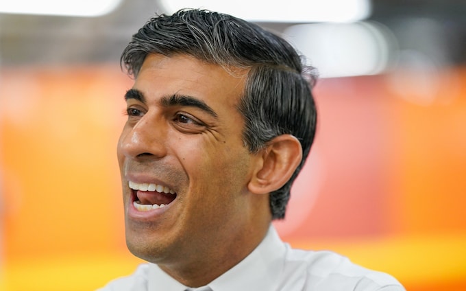 Rishi Sunak speaks to employees as he tours the car manufacturer Nissan