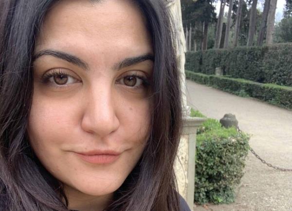 Almara Abgarian taking a selfie outside. There's a gravel path lined with smart hedges/trees in the background. (Picture: Almara Abgarian)
