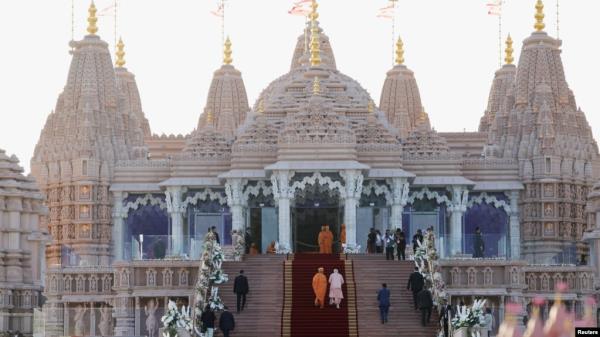 Indian Prime Minister Narendra Modi climbs the stairs as he attends the inauguration of the BAPS Hindu temple in Abu Dhabi, United Arab Emirates, on Feb. 14, 2024.